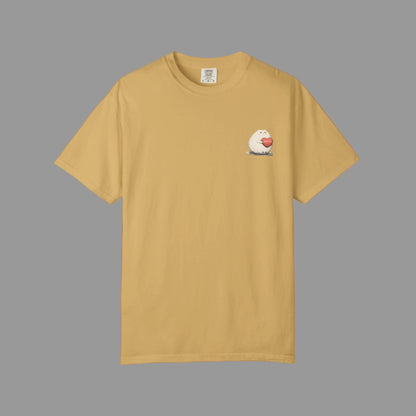 Beige t-shirt with a small graphic on the chest against a white background
