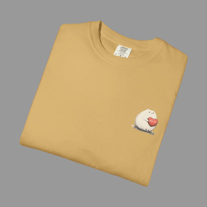 Folded mustard yellow t-shirt with a small graphic on a white background