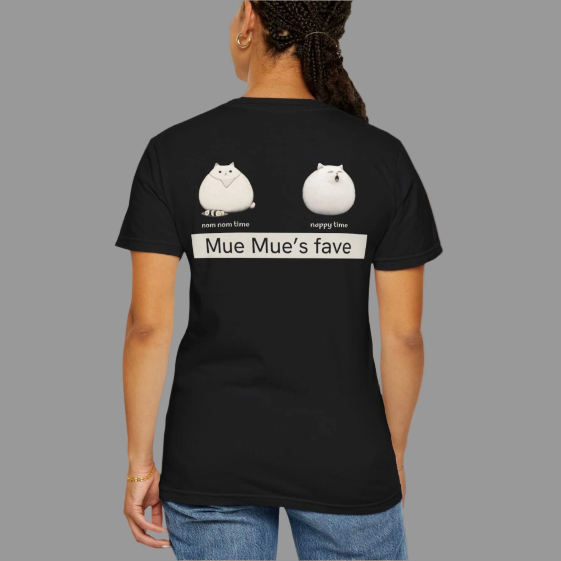 Person wearing a black t-shirt with cartoon cat designs and text on the back.