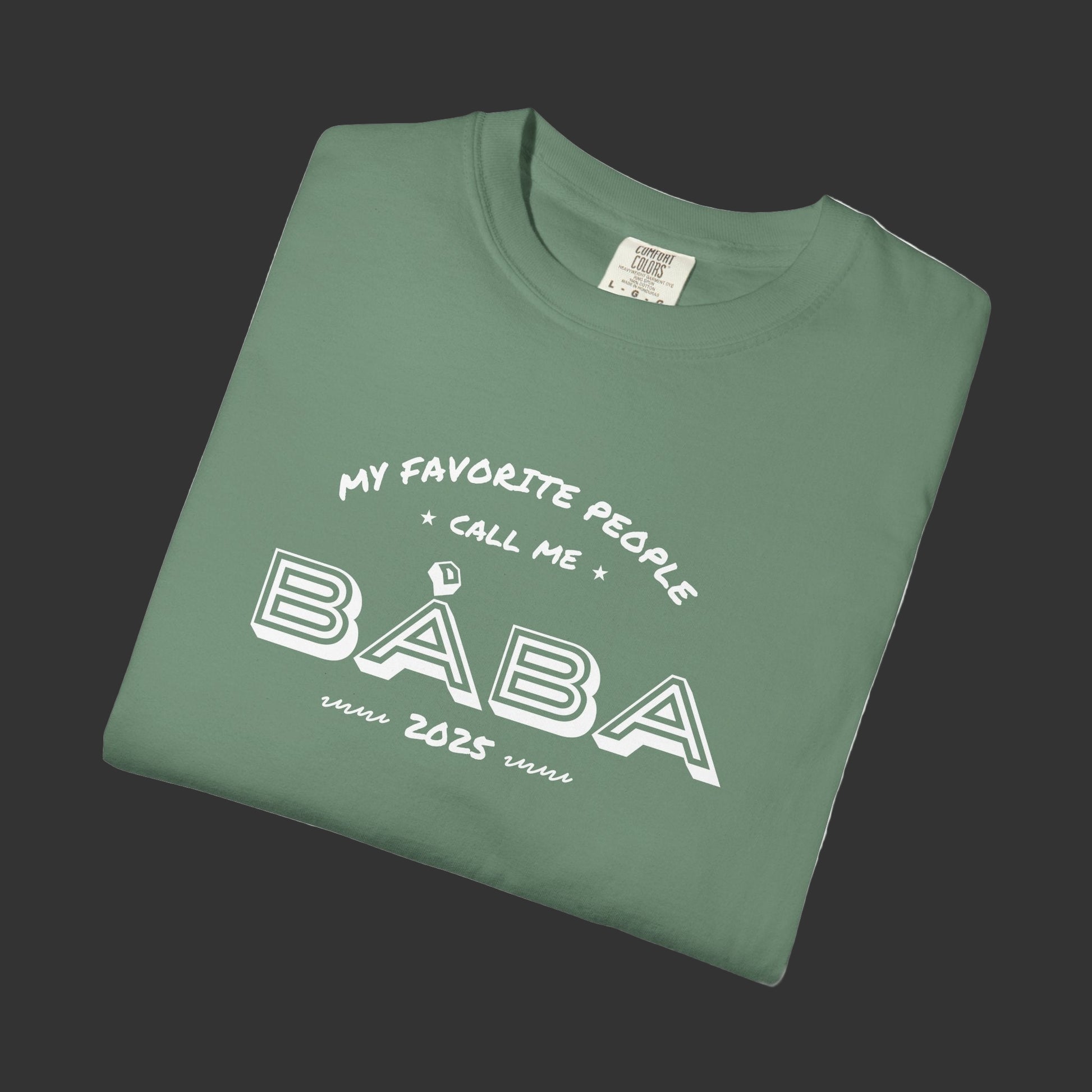 Folded green t-shirt with white text on a white background