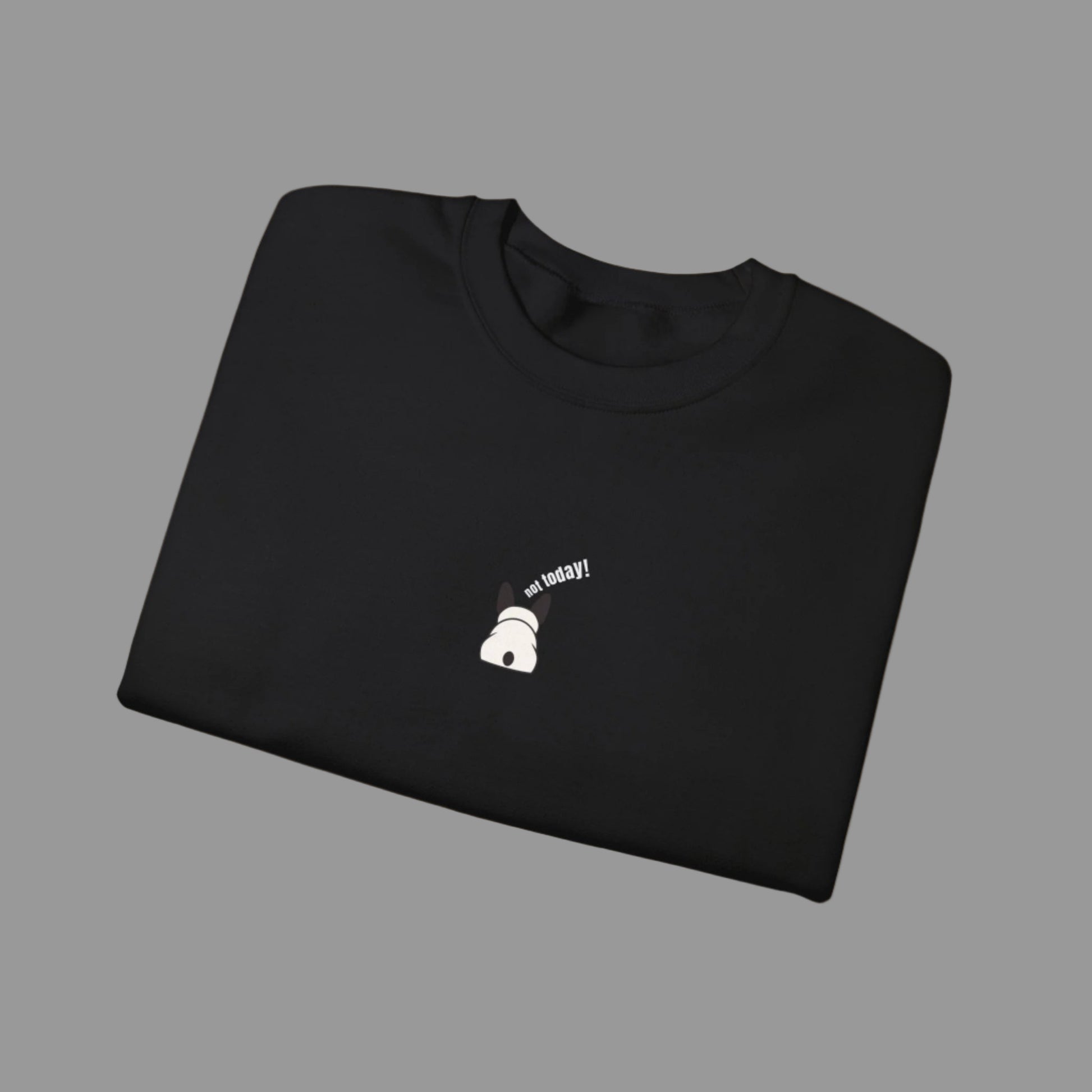 Folded black sweatshirt with a small white graphic and text on a white background