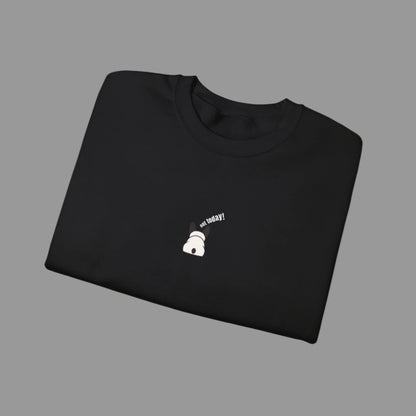 Folded black sweatshirt with a small white graphic and text on a white background