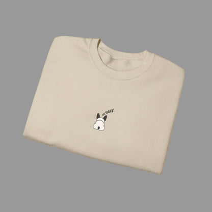 Folded beige t-shirt with a small graphic and text on a white background