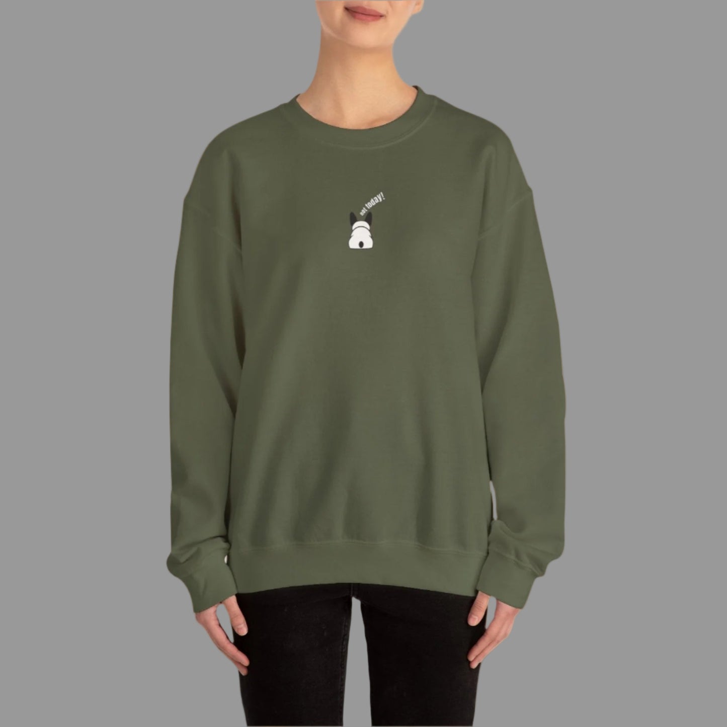 Person wearing a green sweatshirt with a small white graphic on a white background