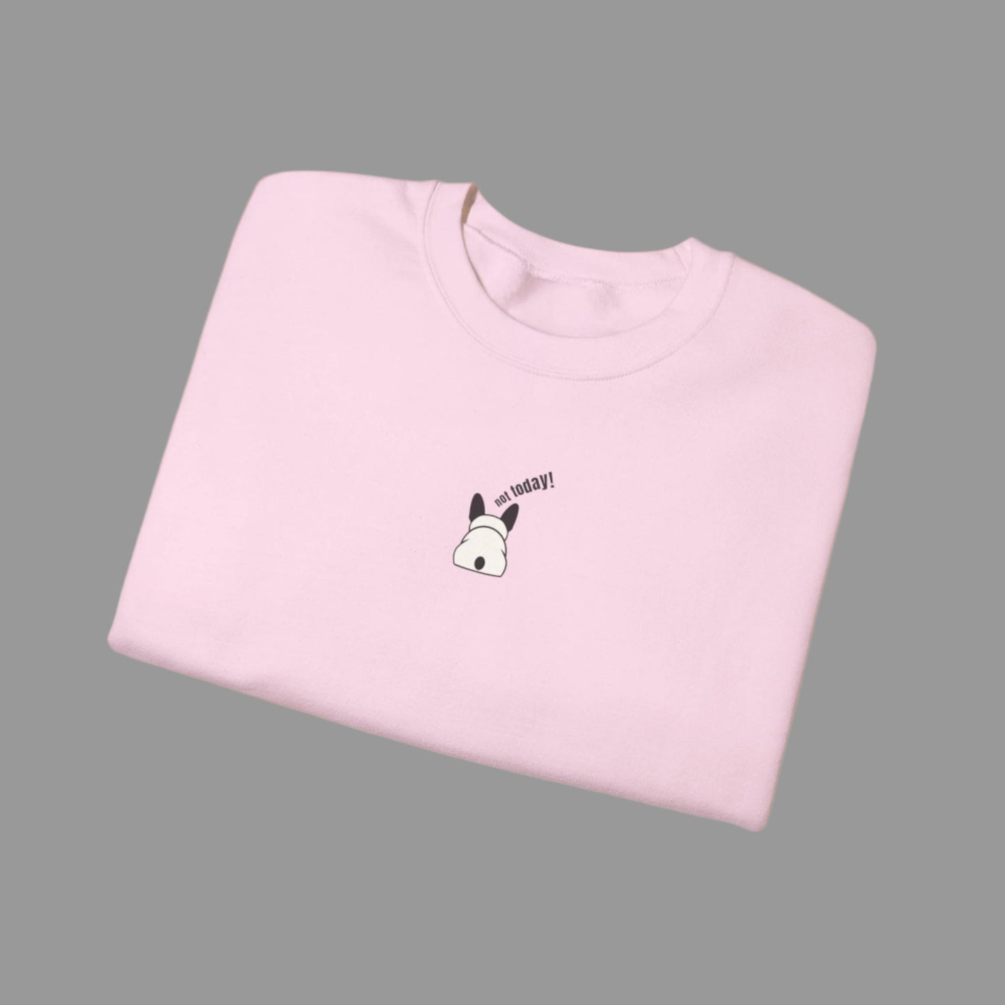 Folded pink t-shirt with a small graphic and text on a white background