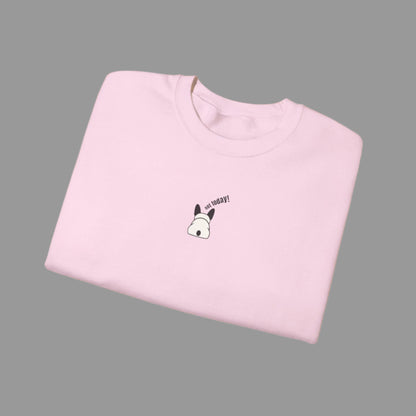 Folded pink t-shirt with a small graphic and text on a white background