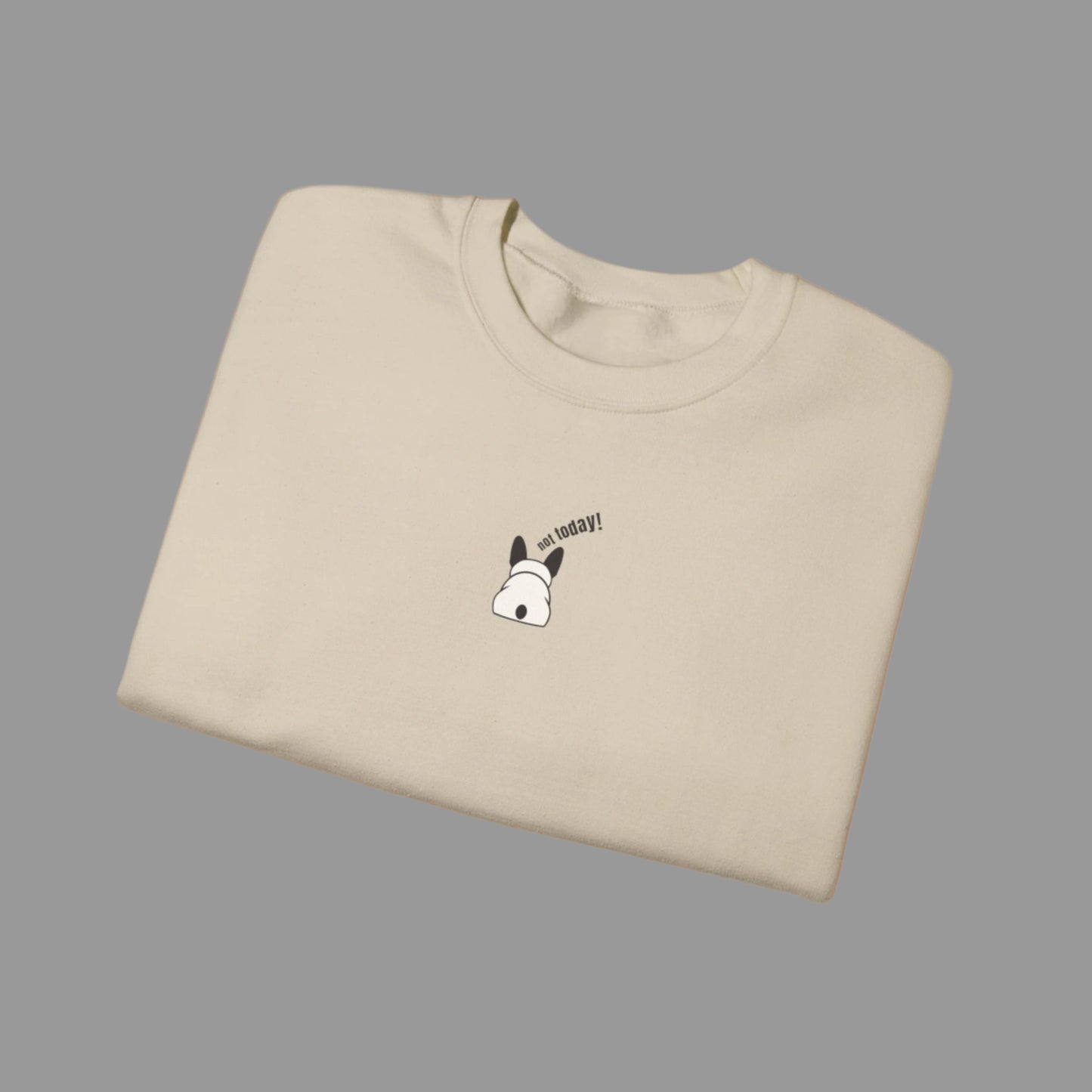 Folded beige t-shirt with a small graphic and text on a white background