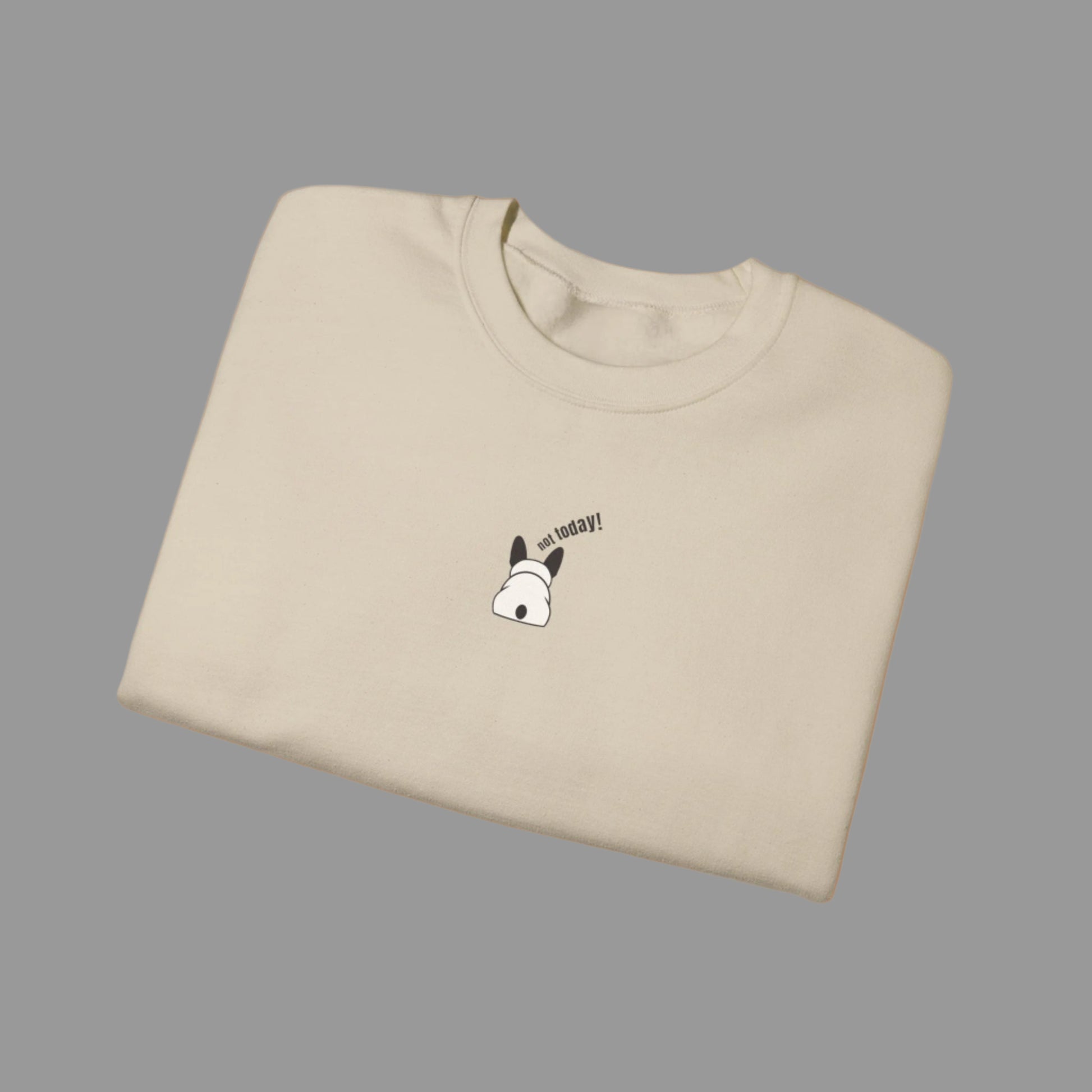 Folded beige t-shirt with a small graphic and text on a white background
