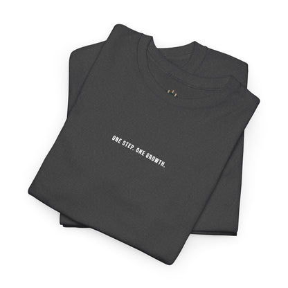 Folded black t-shirt with 'ONE STEP. ONE GROWTH.' text on a white background