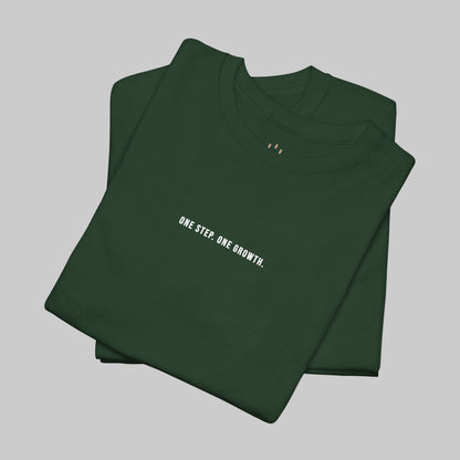 Folded green t-shirt with 'ONE STEP. ONE GROWTH.' text on a white background