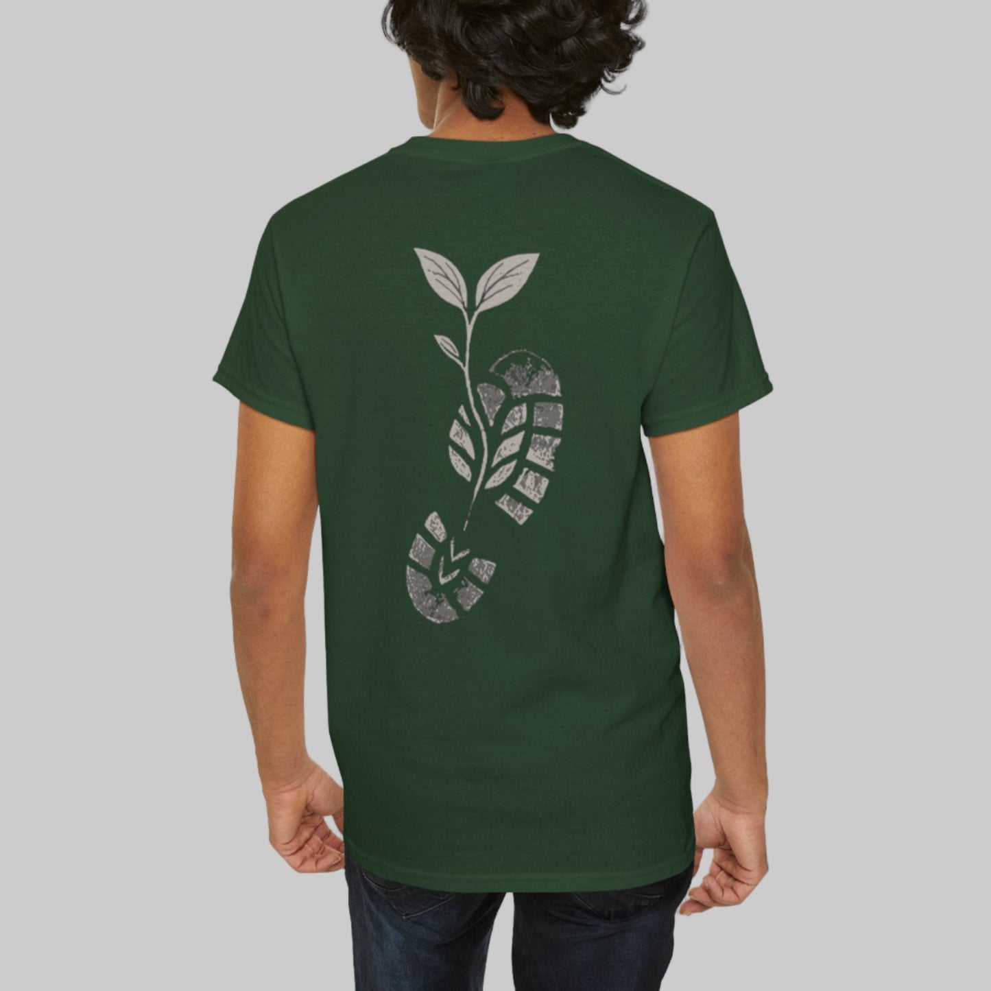 Person wearing a green t-shirt with a leaf design on the back against a white background