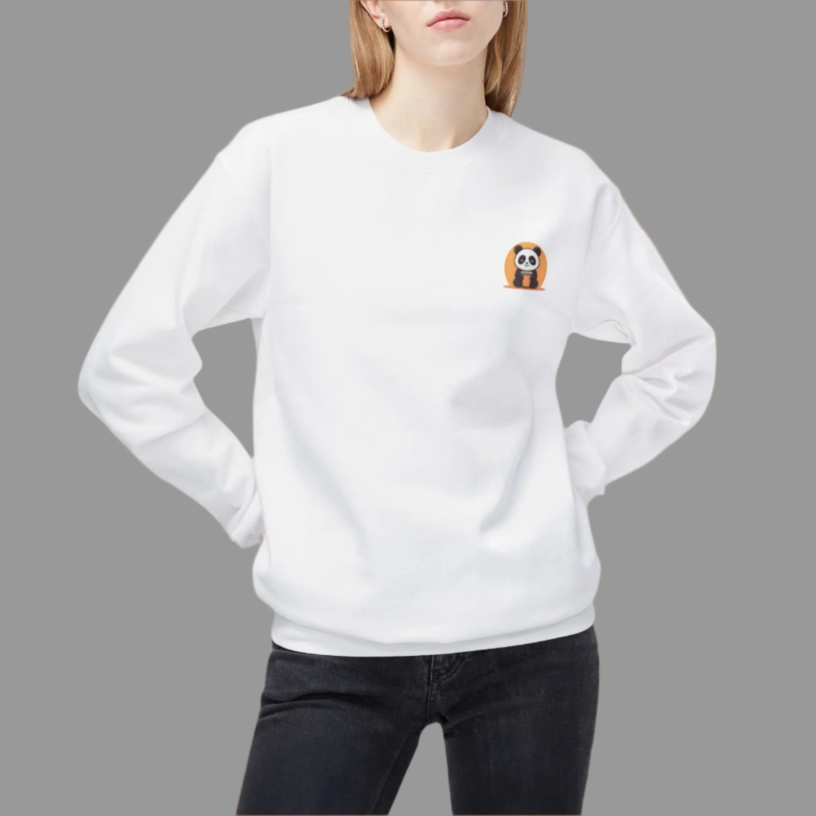 Person wearing a white sweatshirt with a small design on the chest against a white background