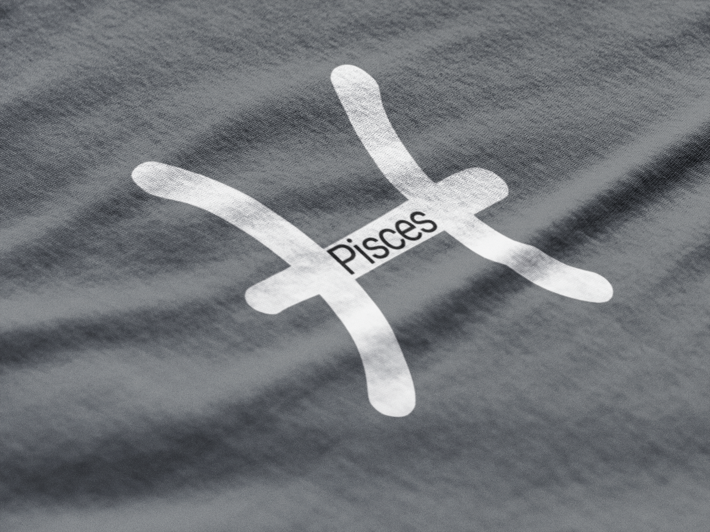 Pisces zodiac symbol on a gray fabric background