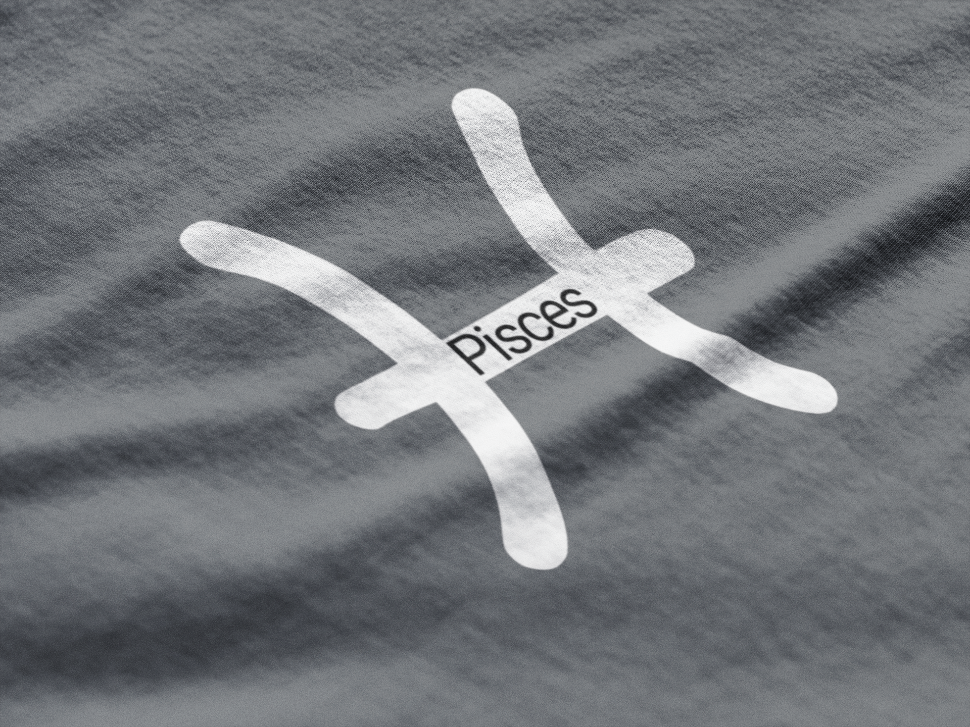 Pisces zodiac symbol on a gray fabric background