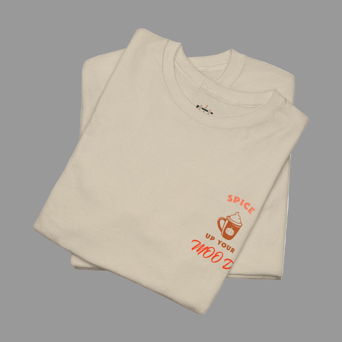 Folded beige t-shirt with red text and graphics on a white background