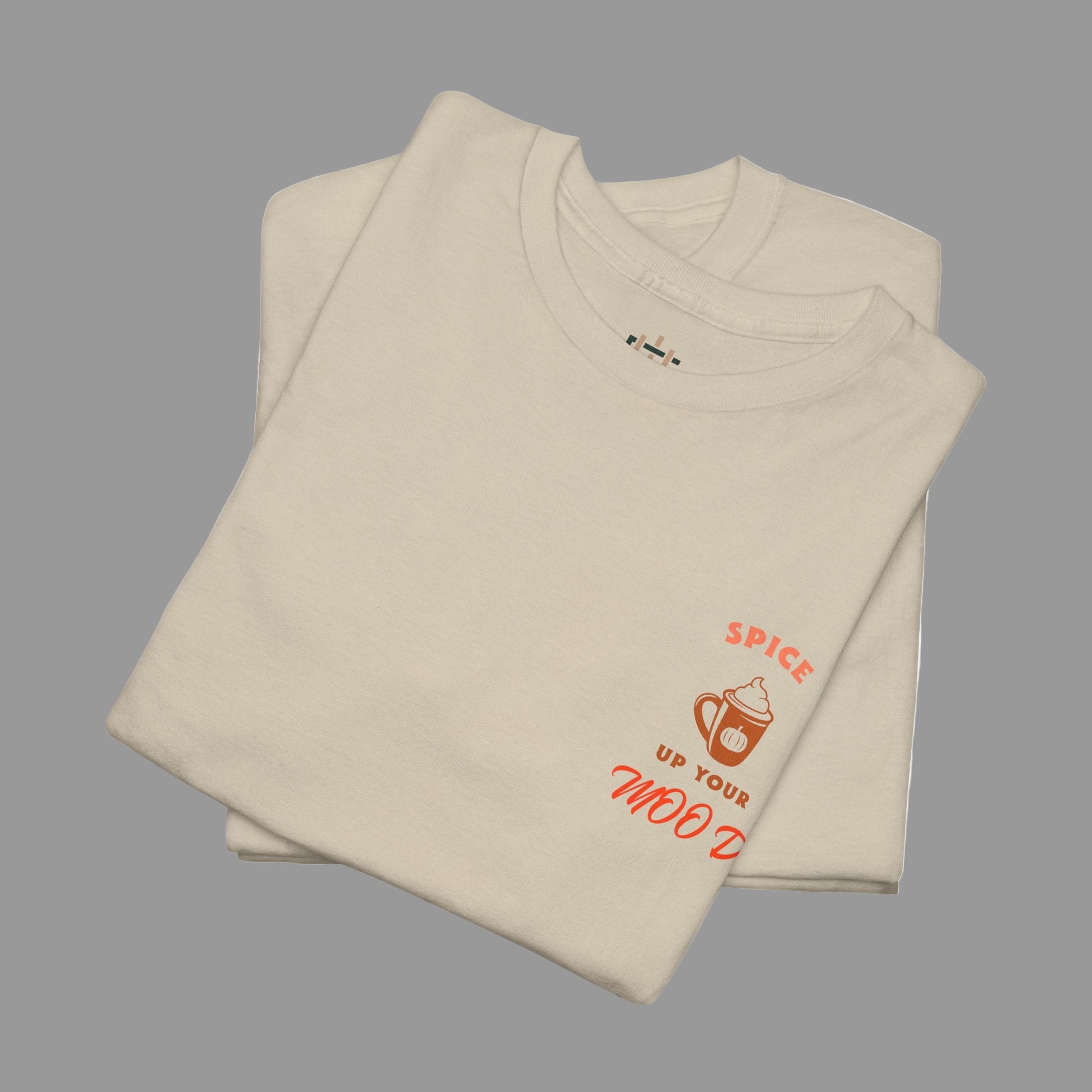 Folded beige t-shirt with red text and graphics on a white background