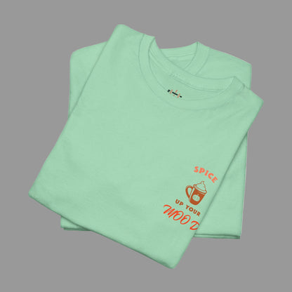 Folded light green t-shirt with orange text and graphics on a white background