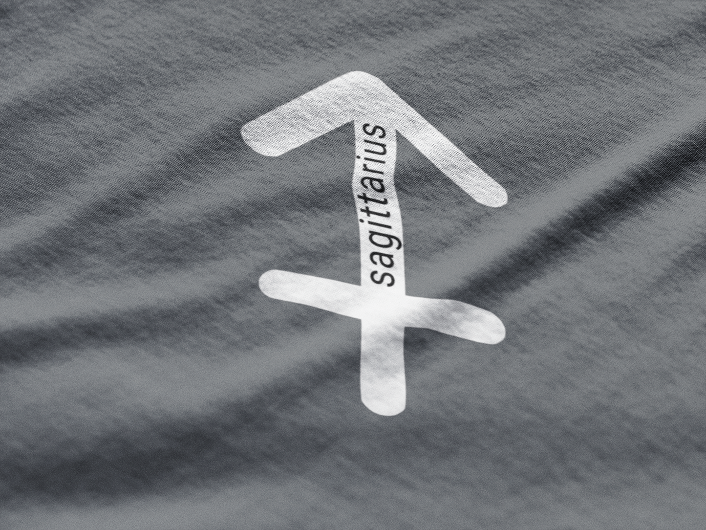White Sagittarius zodiac symbol on gray fabric
