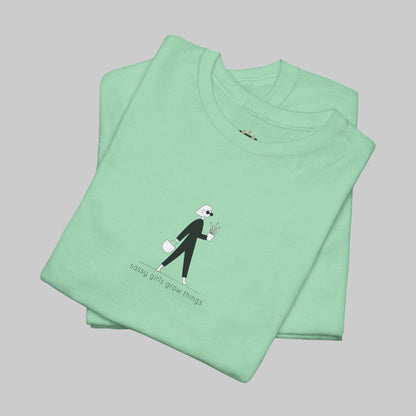 Folded green t-shirt with a graphic design on a white background