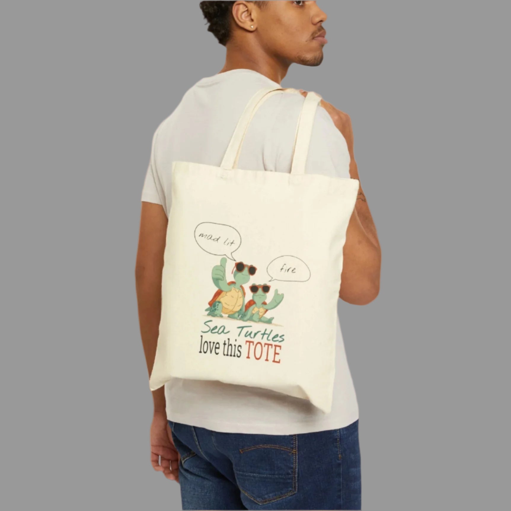 Man holding a tote bag with sea turtle design and text