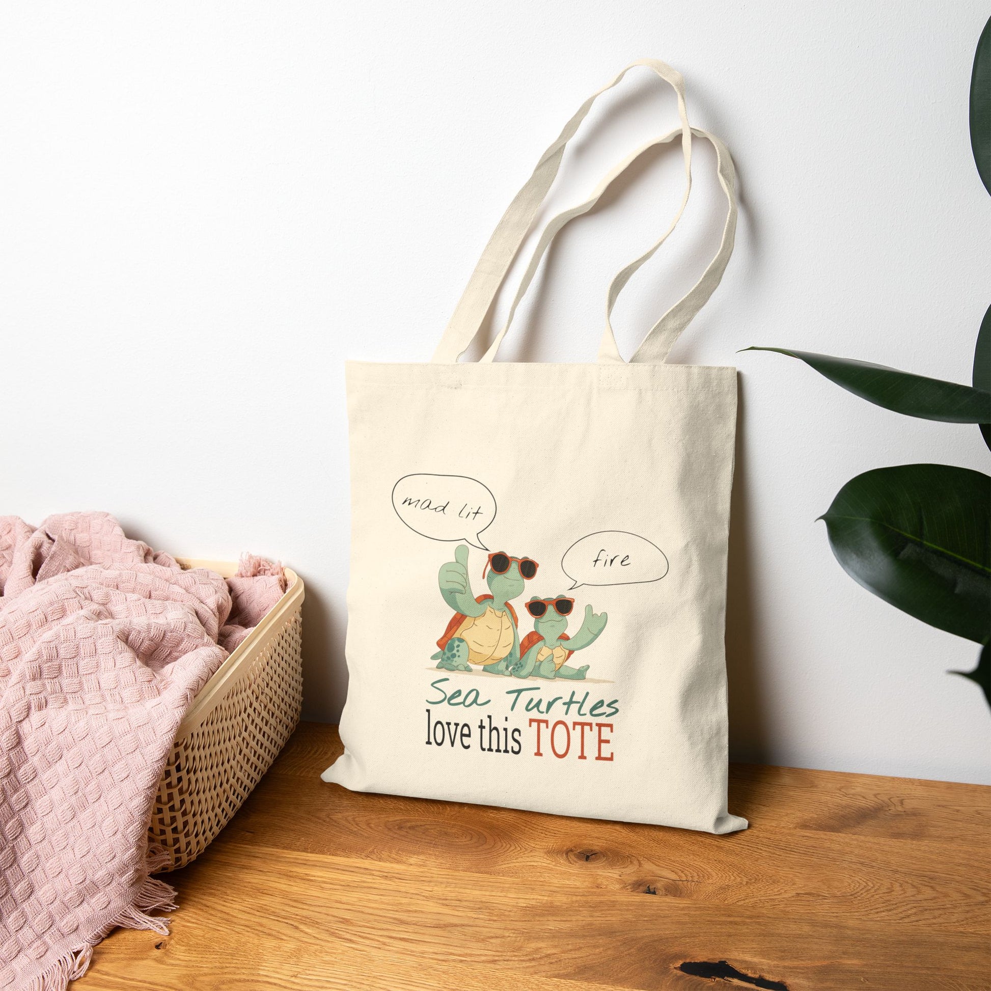 Tote bag with sea turtle design and text on a wooden surface with a white wall background
