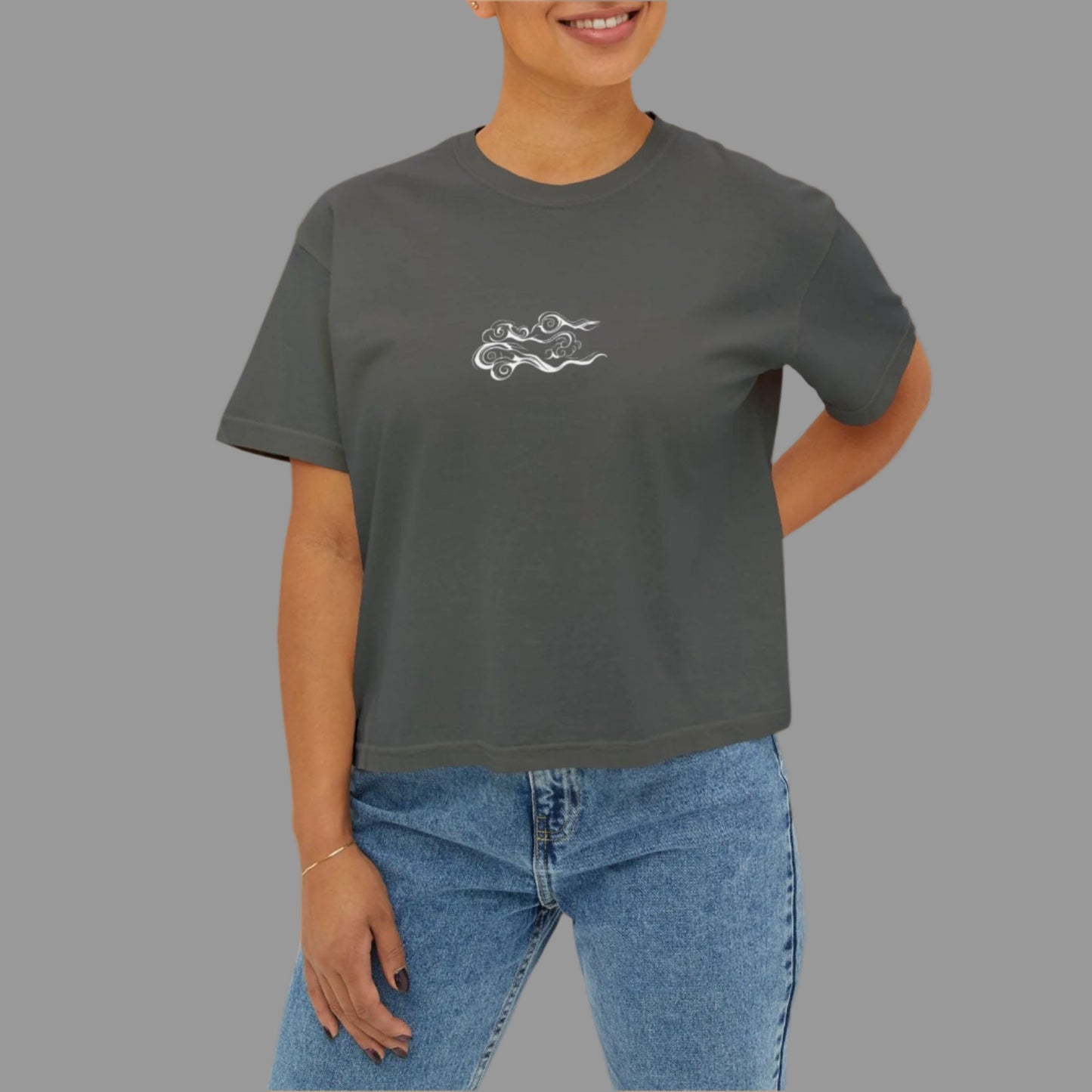 Woman wearing a dark gray t-shirt with a white logo on a white background