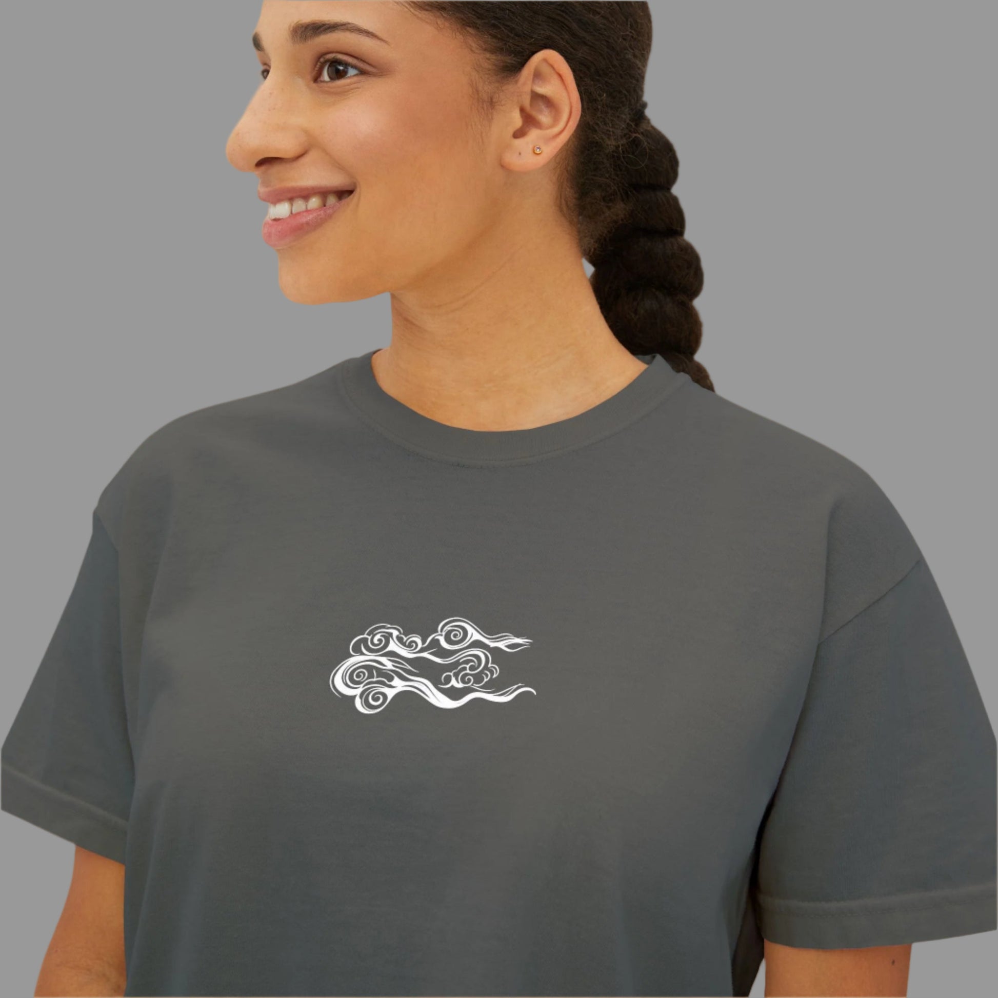 Woman wearing a gray t-shirt with a white logo on a white background