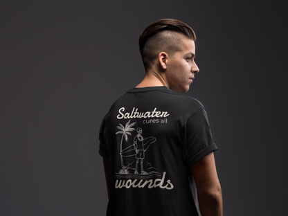 Person wearing a black t-shirt with 'Saltwater cures all wounds' text and graphic on the back against a dark background