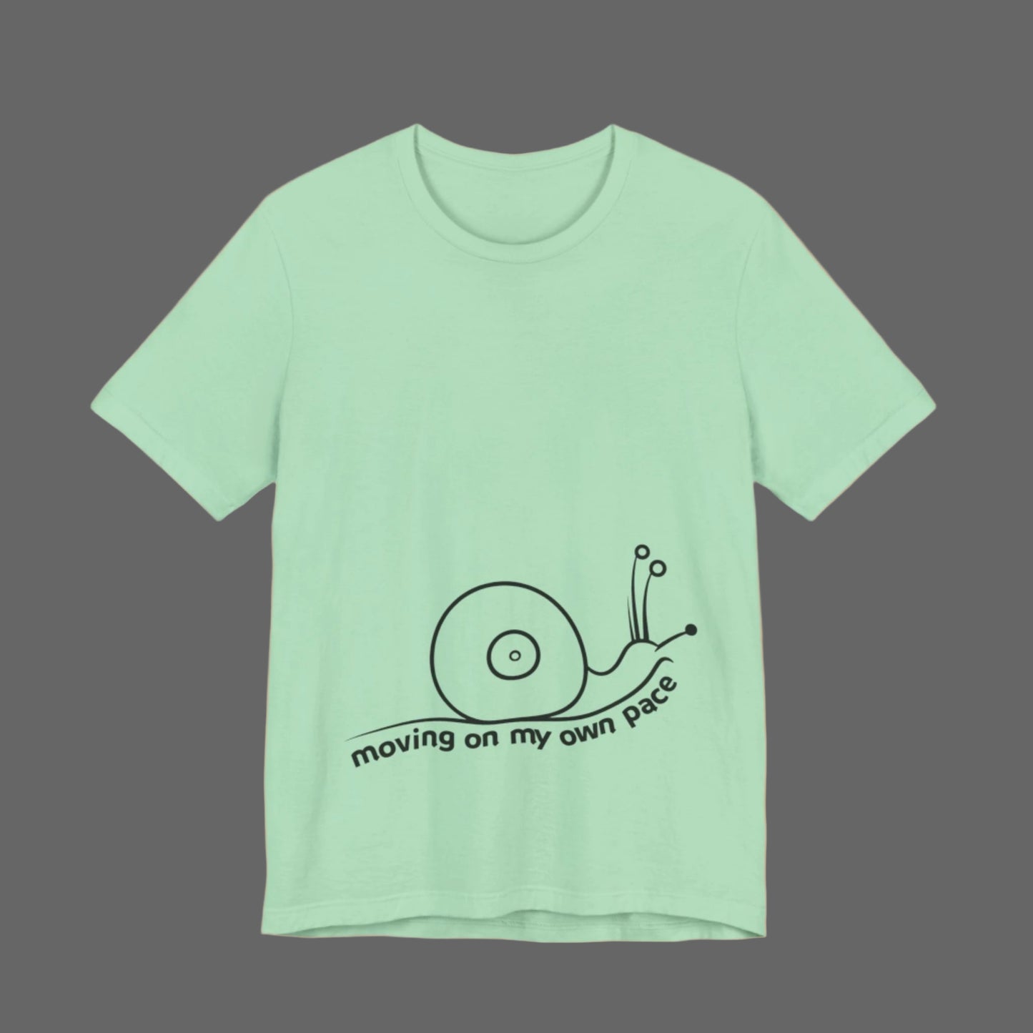 Mint green t-shirt with a snail graphic and text on a white background