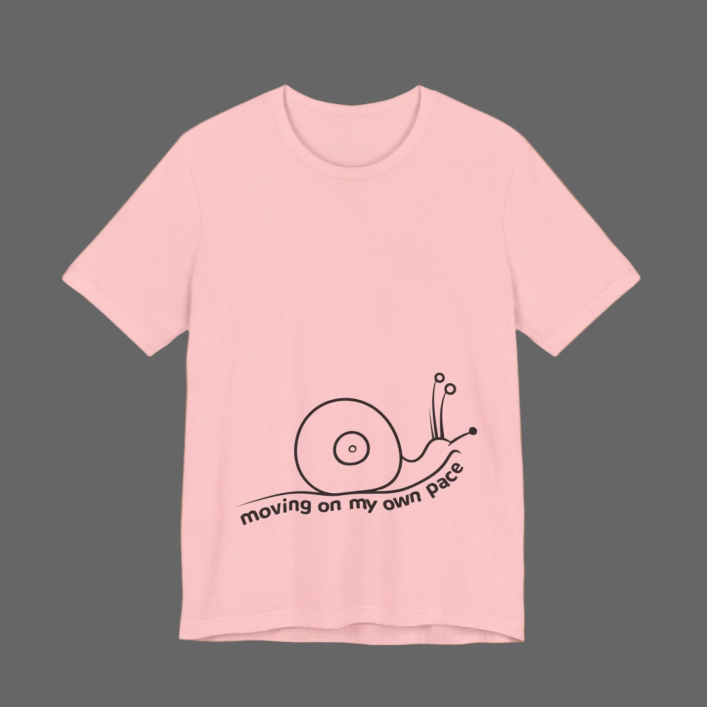 Pink t-shirt with a snail graphic and text on a white background