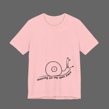 Pink t-shirt with a snail graphic and text on a white background