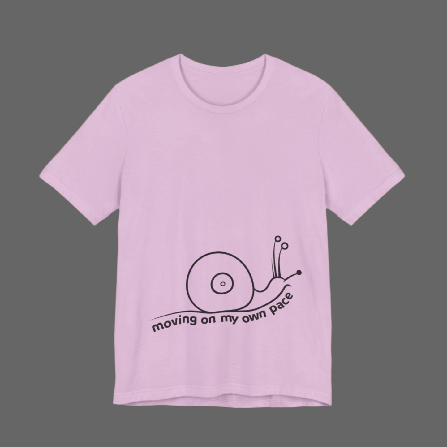 Pink t-shirt with a snail graphic and text on a white background