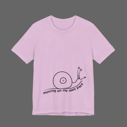 Pink t-shirt with a snail graphic and text on a white background