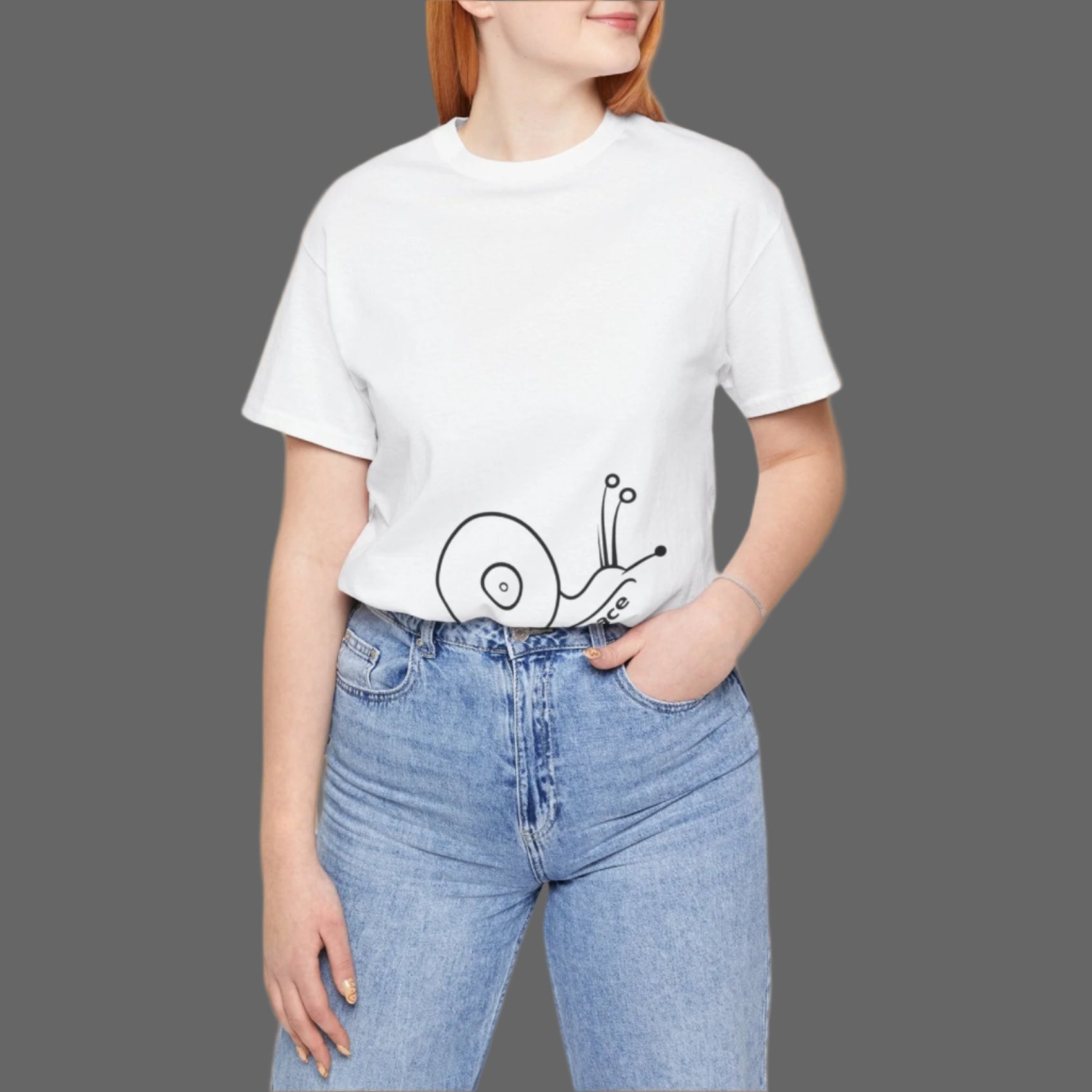Person wearing a white t-shirt with a snail design and blue jeans on a white background