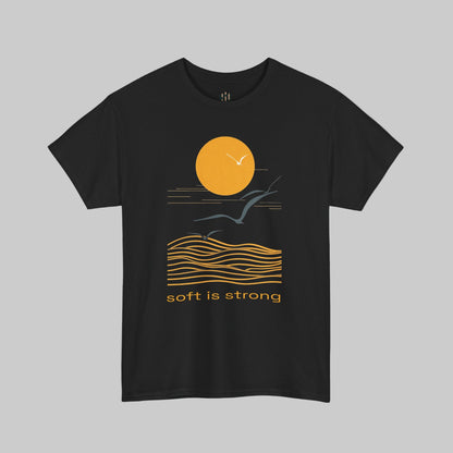 Black t-shirt with a graphic design of a sun, waves, and birds with 'soft is strong' text on a white background.