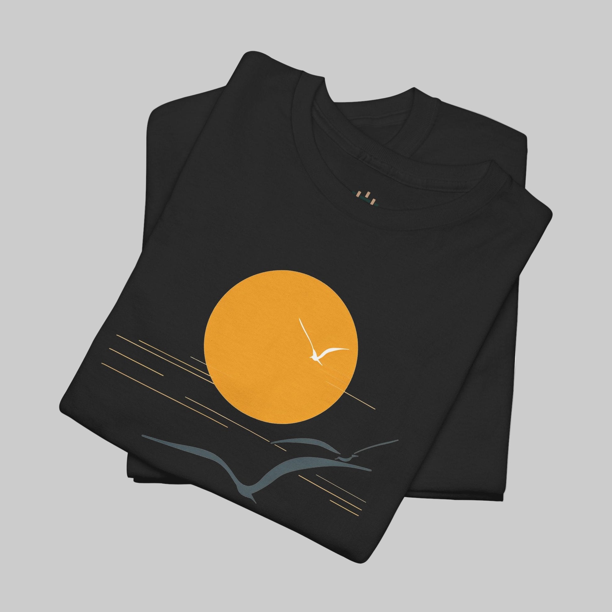 Black t-shirt with a sunset design featuring an orange sun and white bird on a white background