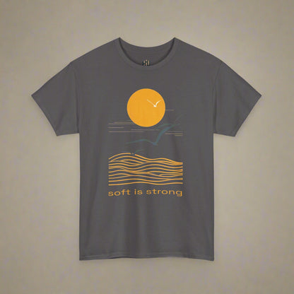 Gray t-shirt with a sunset and wave design and 'soft is strong' text on a white background