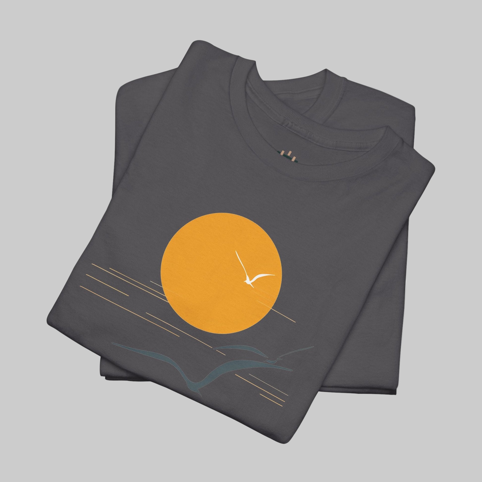Folded t-shirt with a sun and wave design on a white background