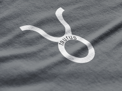 Taurus zodiac symbol on a gray fabric background