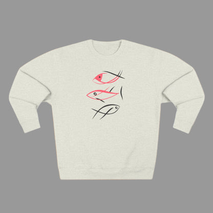 A person wearing a gray crewneck sweatshirt with a minimalist fish graphic design in pink and black.