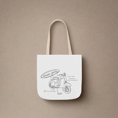 White tote bag with scooter design and text on a white background