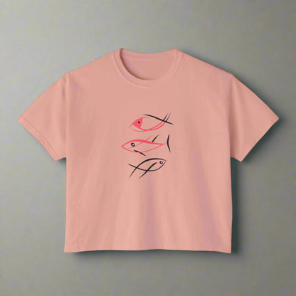 Pink t-shirt with black and red fish illustrations on a white background