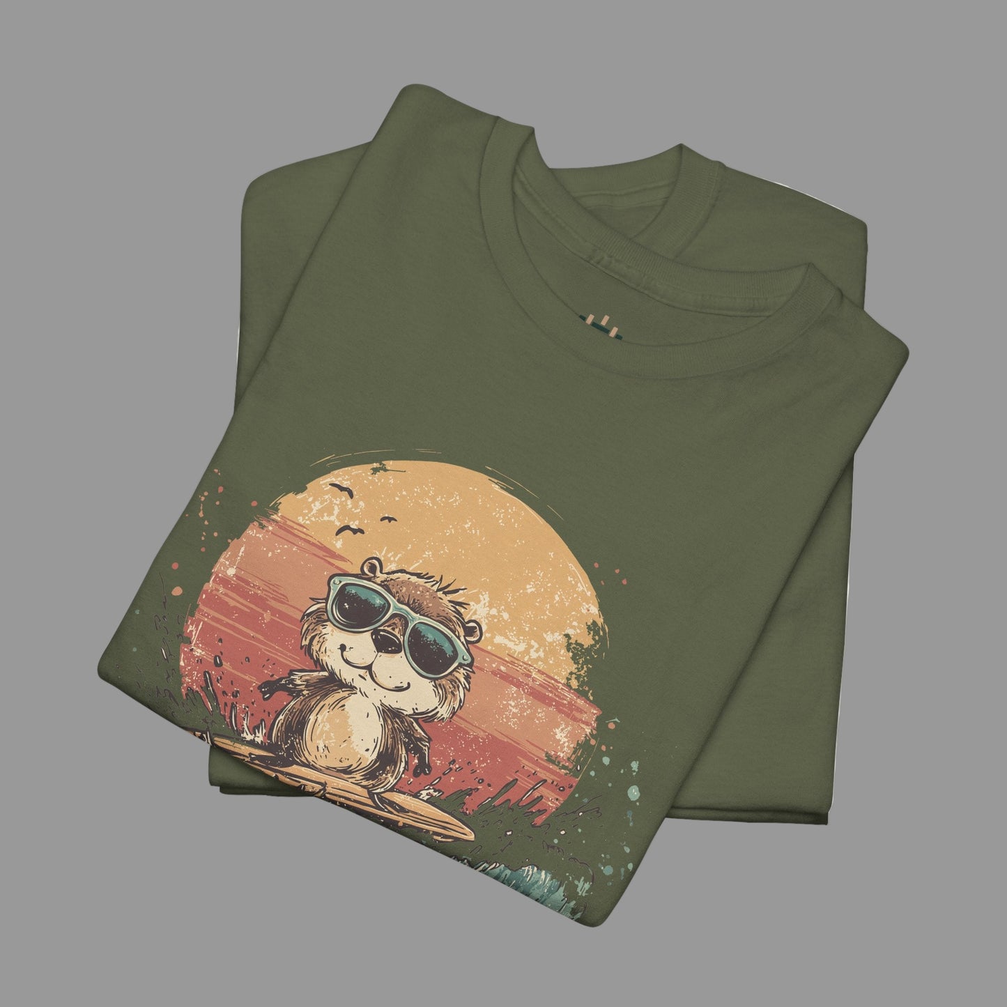 Folded green t-shirt with a graphic of a monkey wearing sunglasses on a sunset background.