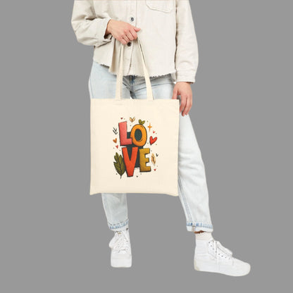 Person holding a tote bag with 'LOVE' printed on it against a white background