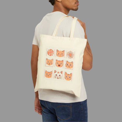 Man carrying a tote bag with cat illustrations on a white background
