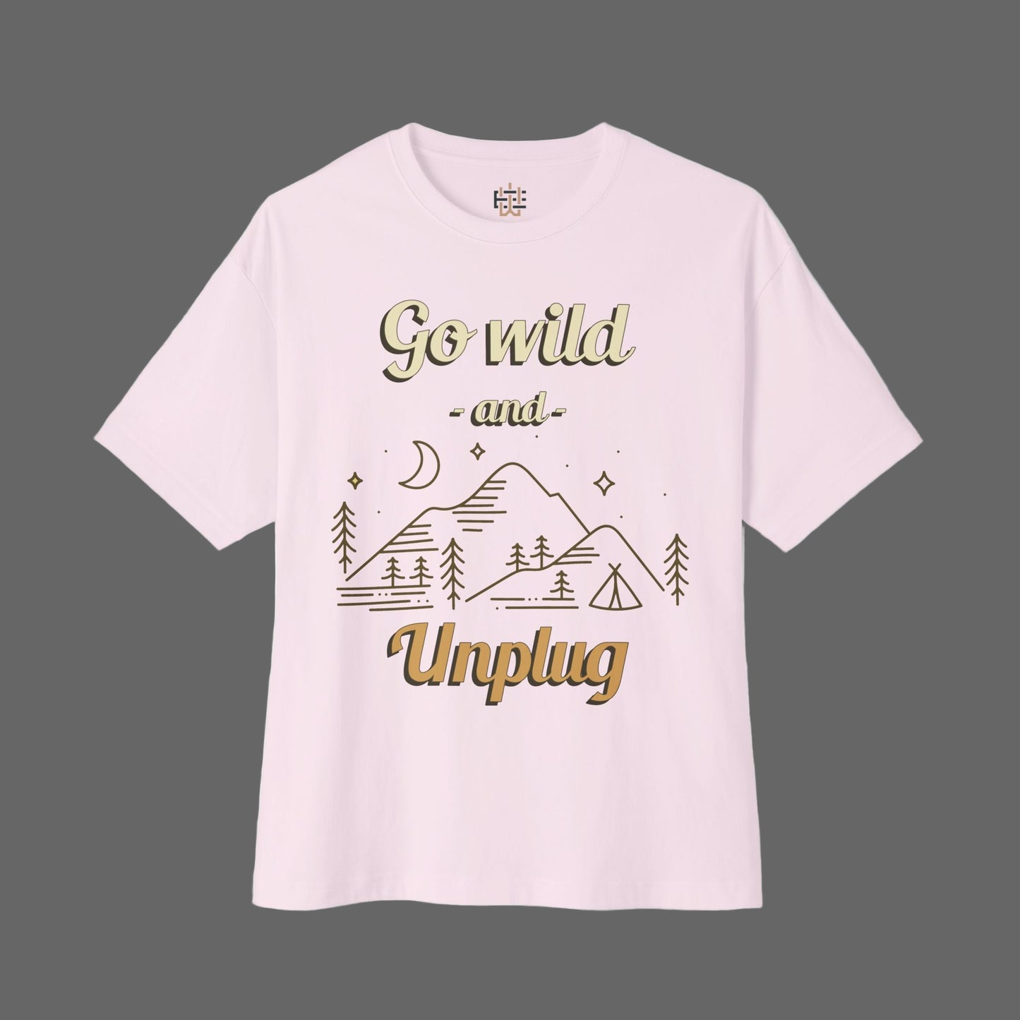 Pink t-shirt with gold text and mountain graphic on a white background