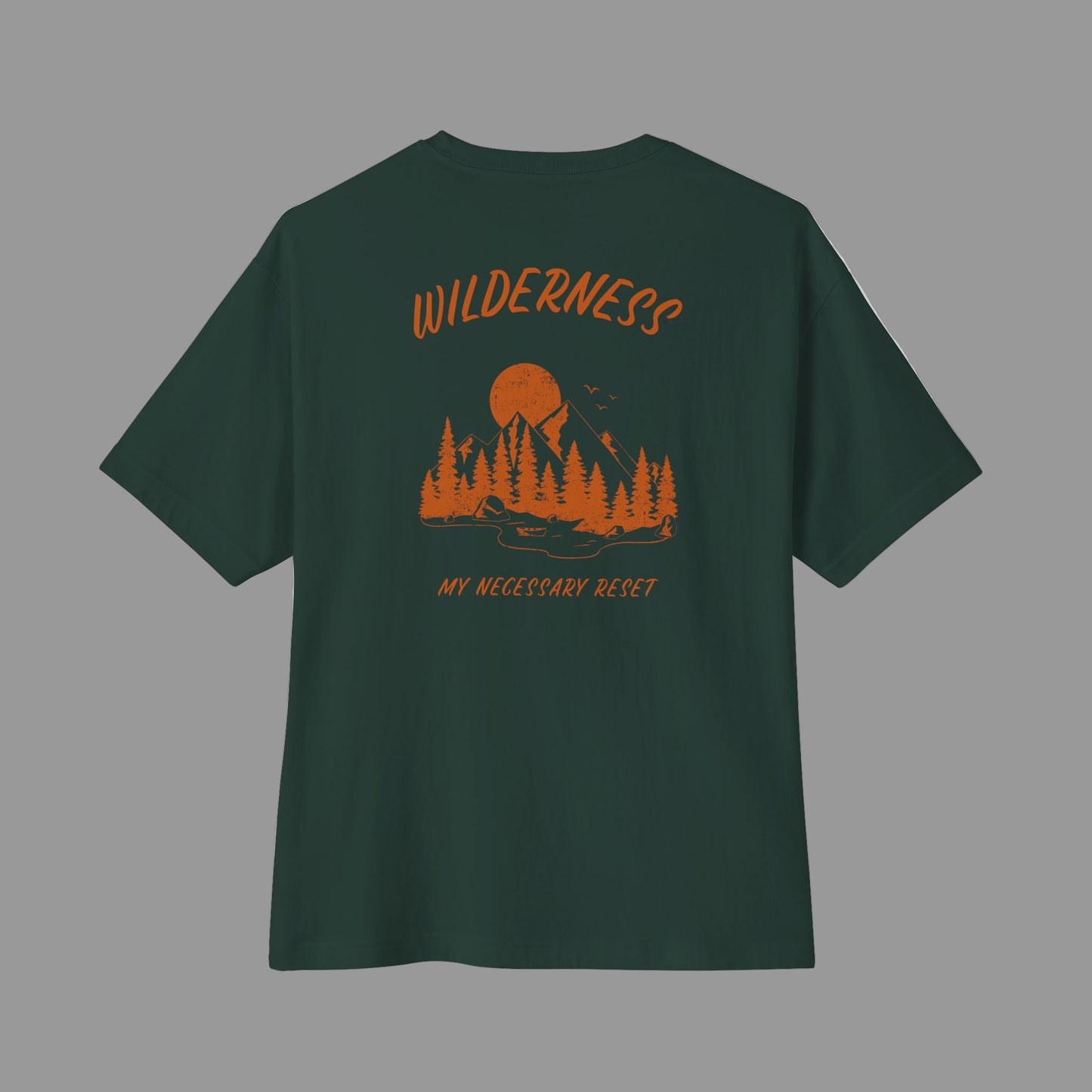Green t-shirt with orange wilderness graphic and text on a white background