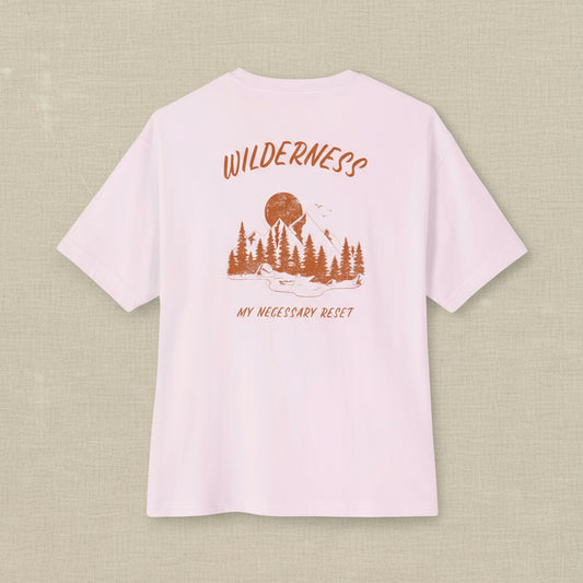 Pink t-shirt with nature-themed design and text on a white background
