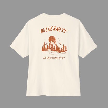 Beige t-shirt with 'Wilderness My Necessary Reset' design on a white background