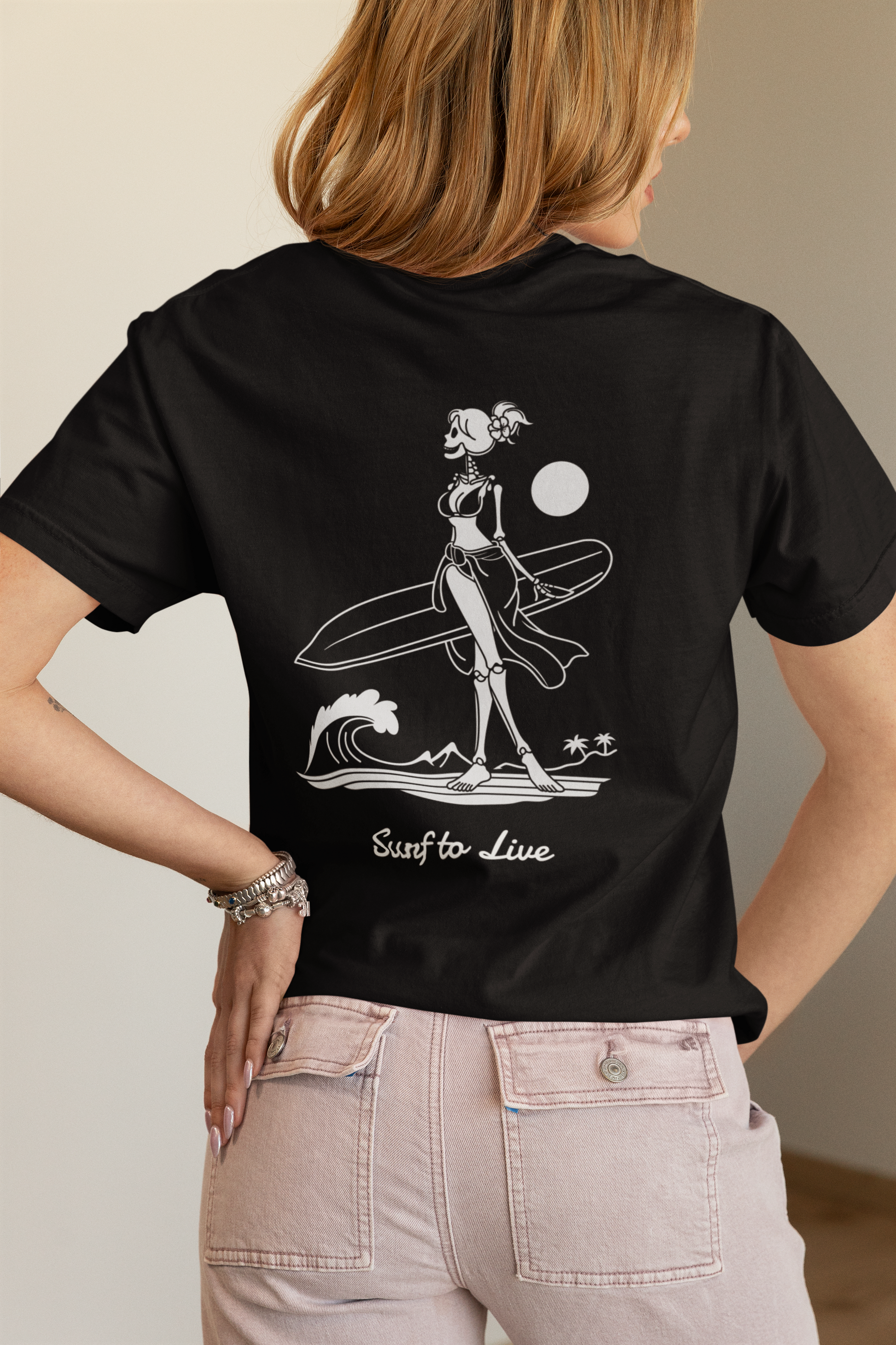 Person wearing a black t-shirt with a graphic design on the back, standing against a neutral background.